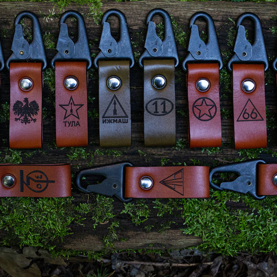 Leather customizable keychains with HK snap hooks and various logos engraved on each, including Izhmash, Tula, FB Radom, Norinco, and more.